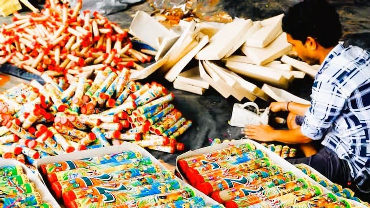 Workers pack varieties of firecrackers for sale ahead of the 'Diwali' festival.